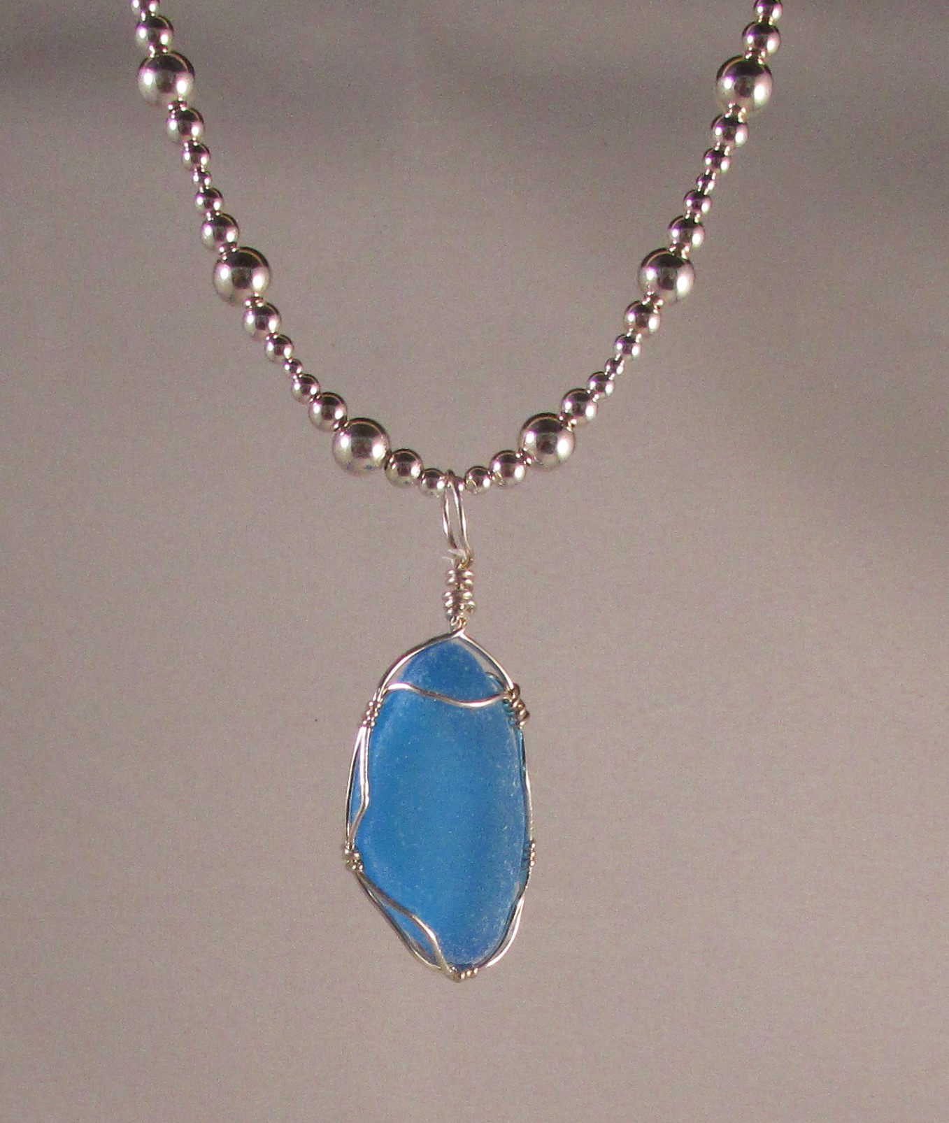 Electric Aqua Italian Parcial Bottle Pendant Wrapped in a Sterling Silver Basket on a Sterling Silver Chain